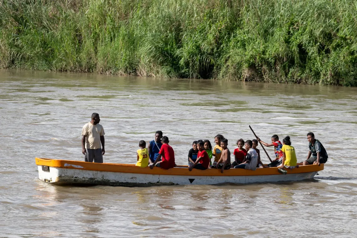 Younger students cross the Kemp Welch River daily on a small dinghy to get to and from school.