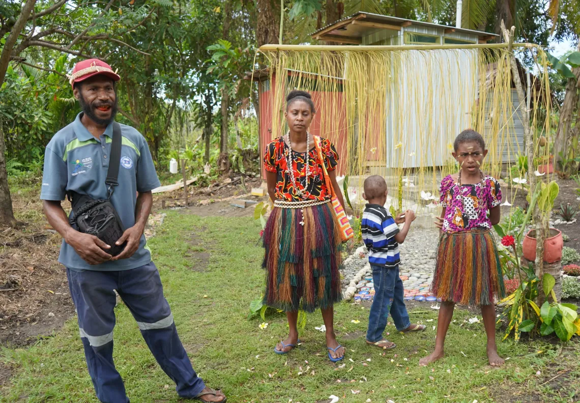 Gideon and his family in front of their new toilet