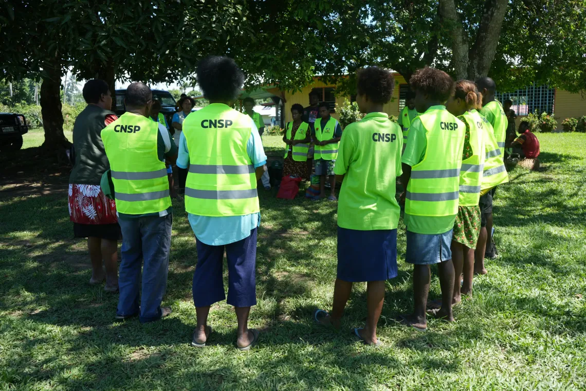Village Health Assistants gather for a briefing before heading out to communities for the household monitoring survey.