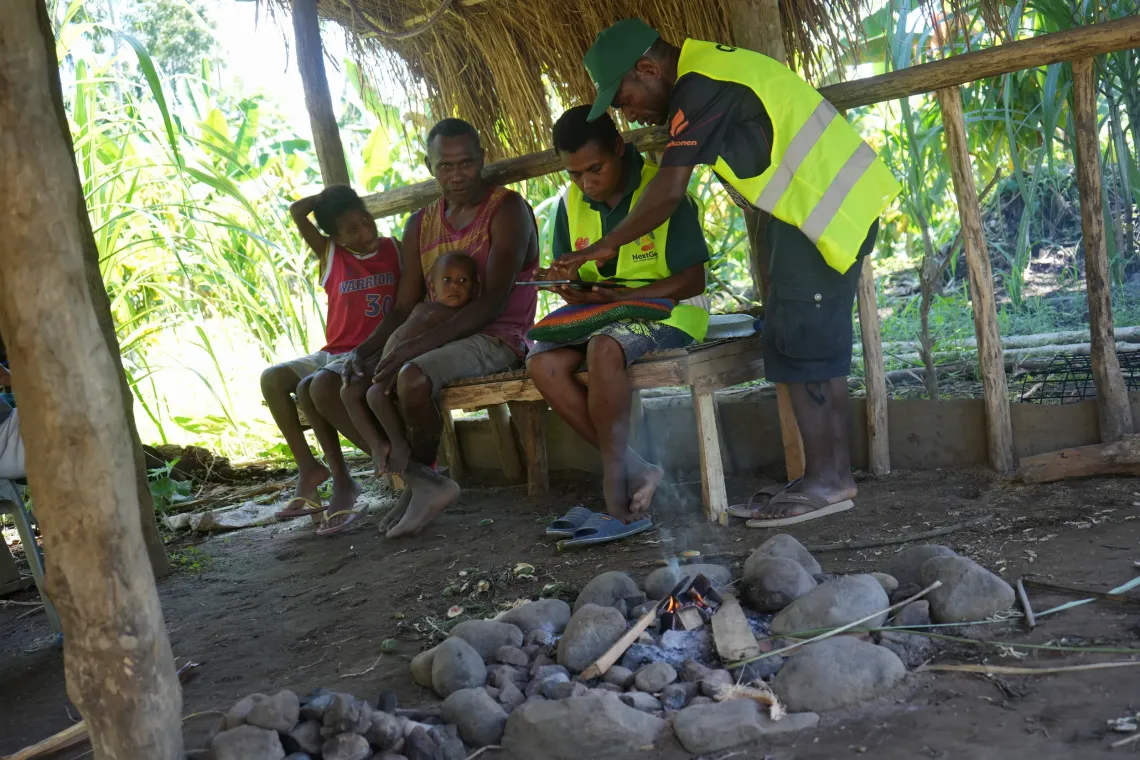 Village Health Assistants interview a family and record key information during the household monitoring visit.