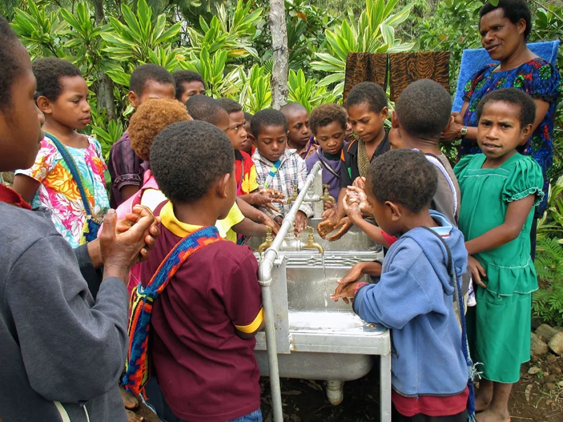 Elementary students wash their hands before getting back to class