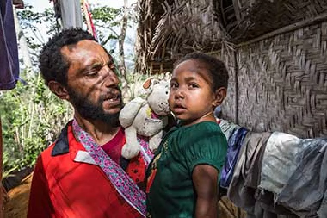 Haddesha and her father outside their family home