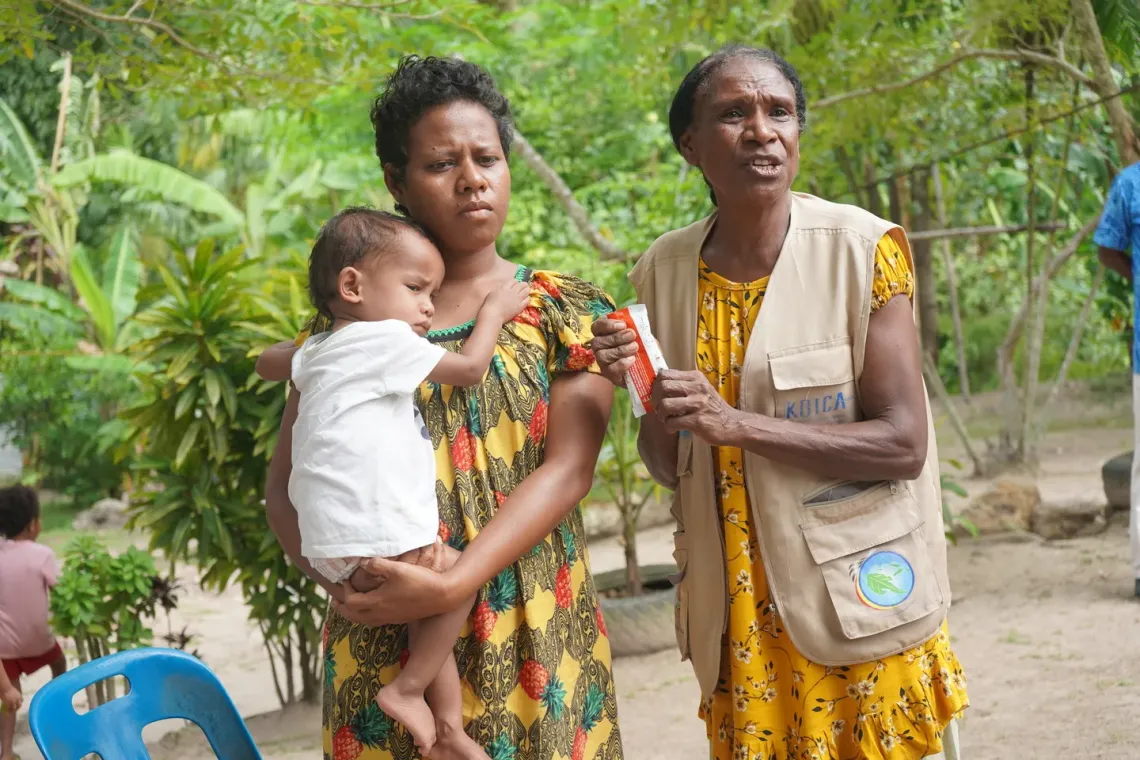 Joan (right) explains how RUTF is helping Vali recover from severe acute malnutrition