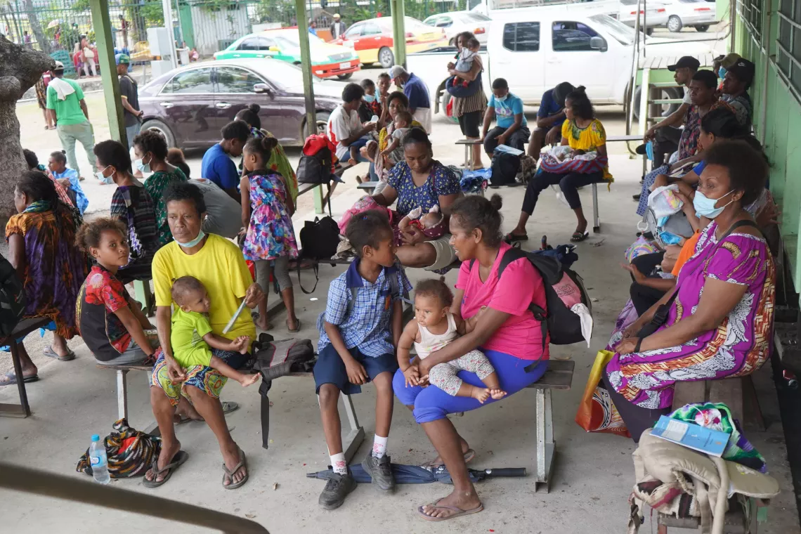 Parents and caregivers patiently await vaccinations for their babies at the 6 Mile Clinic  which offers daily immunization services.
