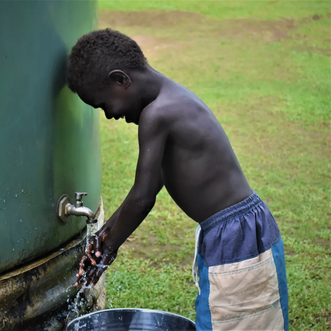A child washing hands.
