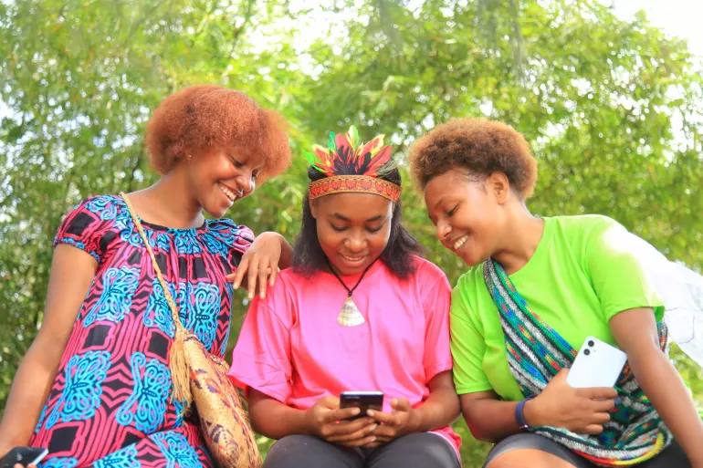 Three girls check out the Oky Global Period Tracking Mobile App that can track their period.