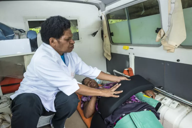 A health worker demonstrates how to apply the anti-shock garment