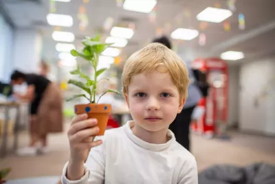 Dana, 5, originally from Kharkiv in Northeast Ukraine, posing with a plant made during nature class at Edu Hub in Warsaw.