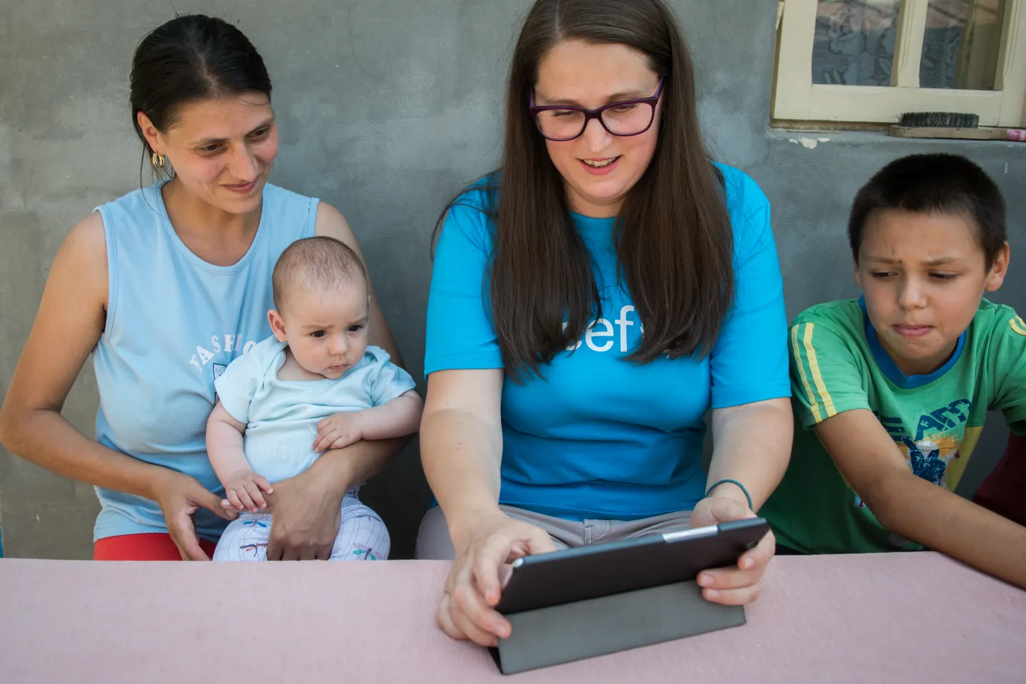 A social worker visiting a family and updating information in Aurora