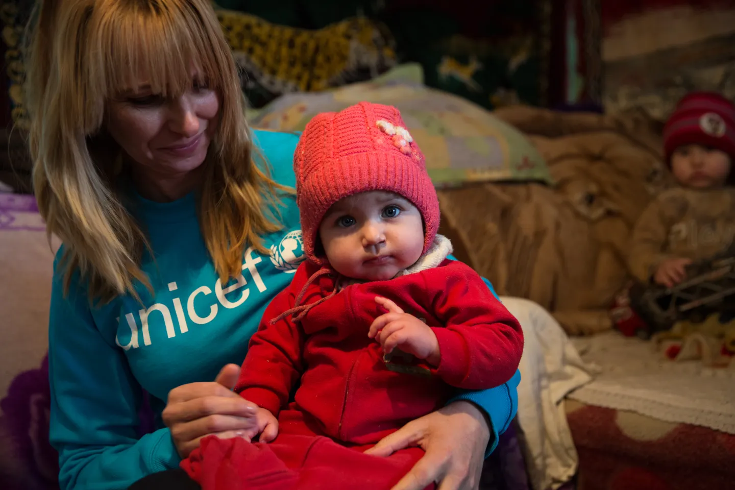 A local professional visiting a vulnerable family and interacting with a child
