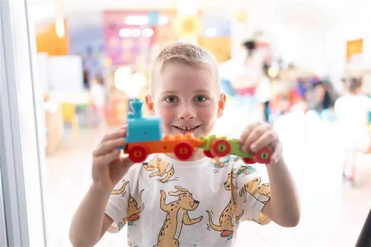 A child holding a train toy