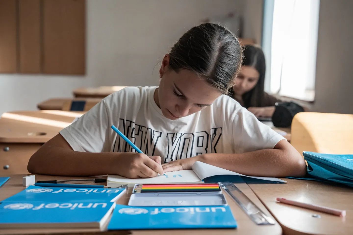 A girl writing in a notebook