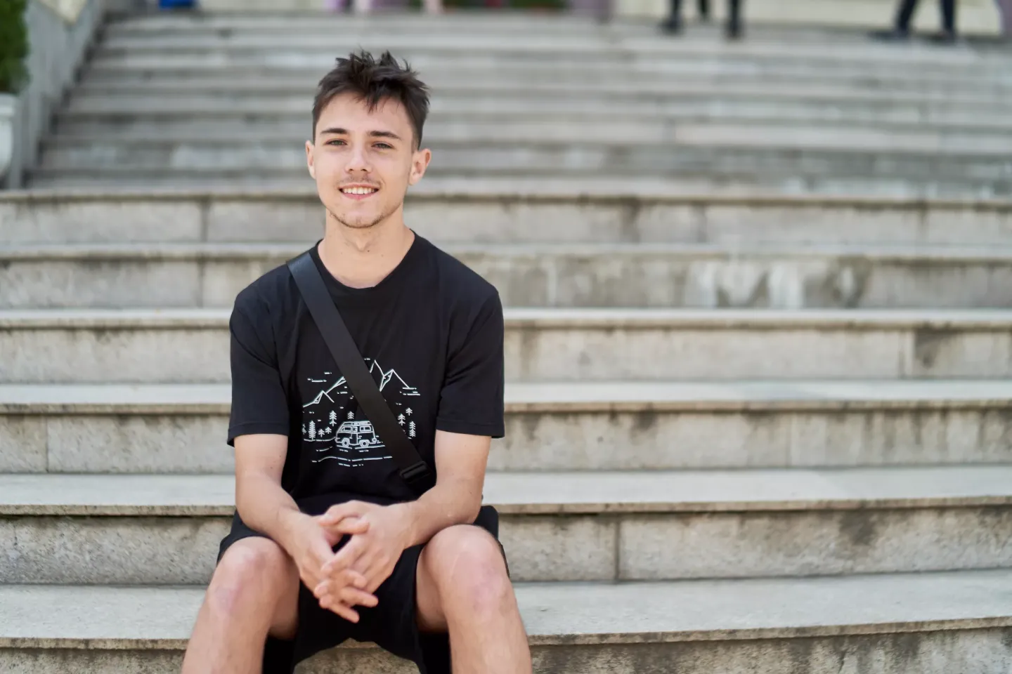 Portrait of a Ukrainian adolescent sitting outside on some stairs. 