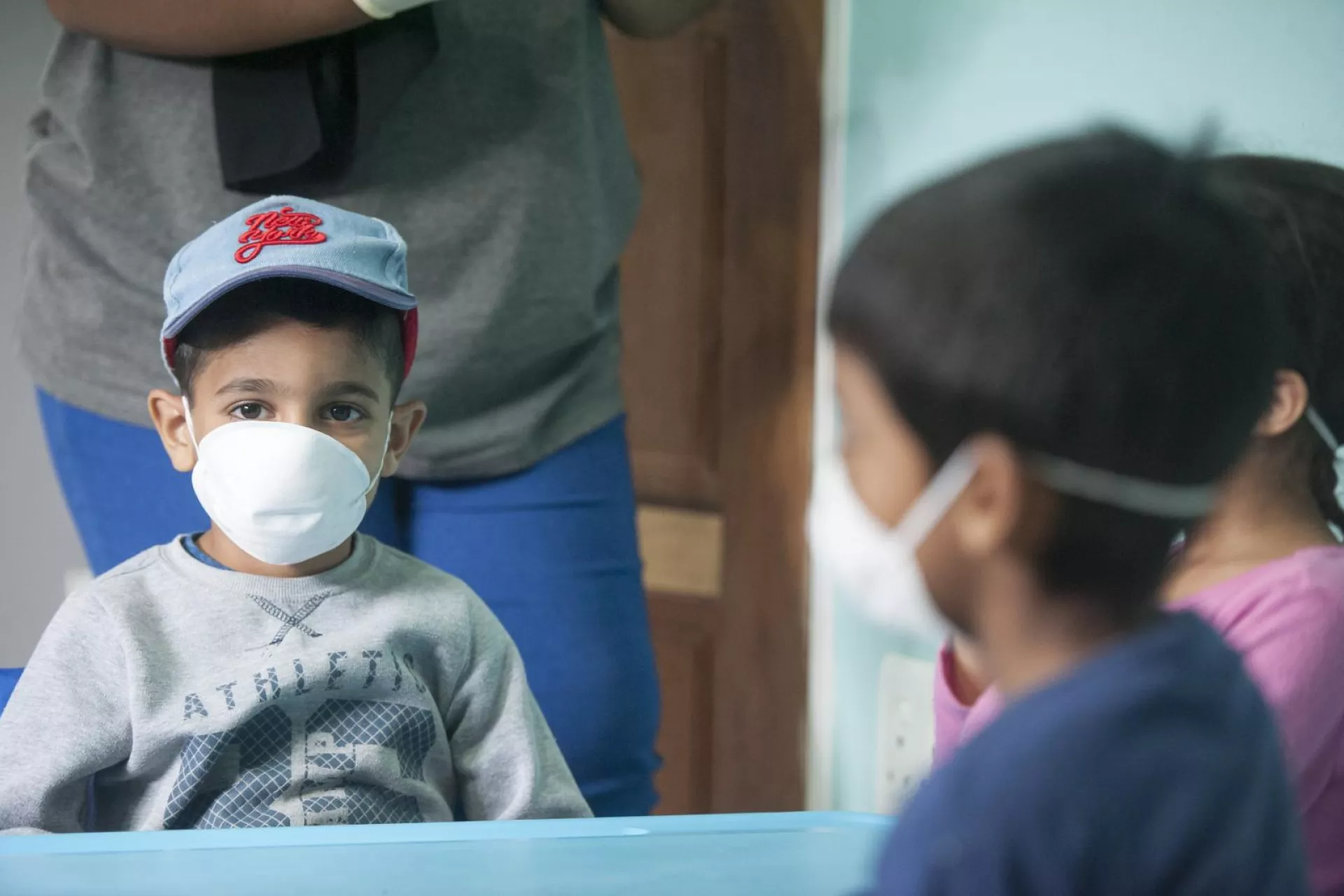 Young boys wear masks to protect against coronavirus
