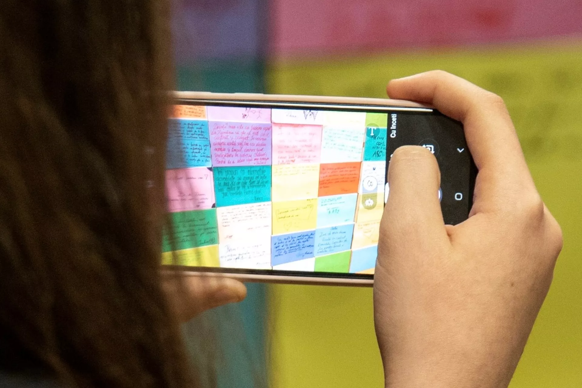 A child takes photos of the wall of commitments built symbolically during a Romanian Children's Board workshop on January 13, 2020.