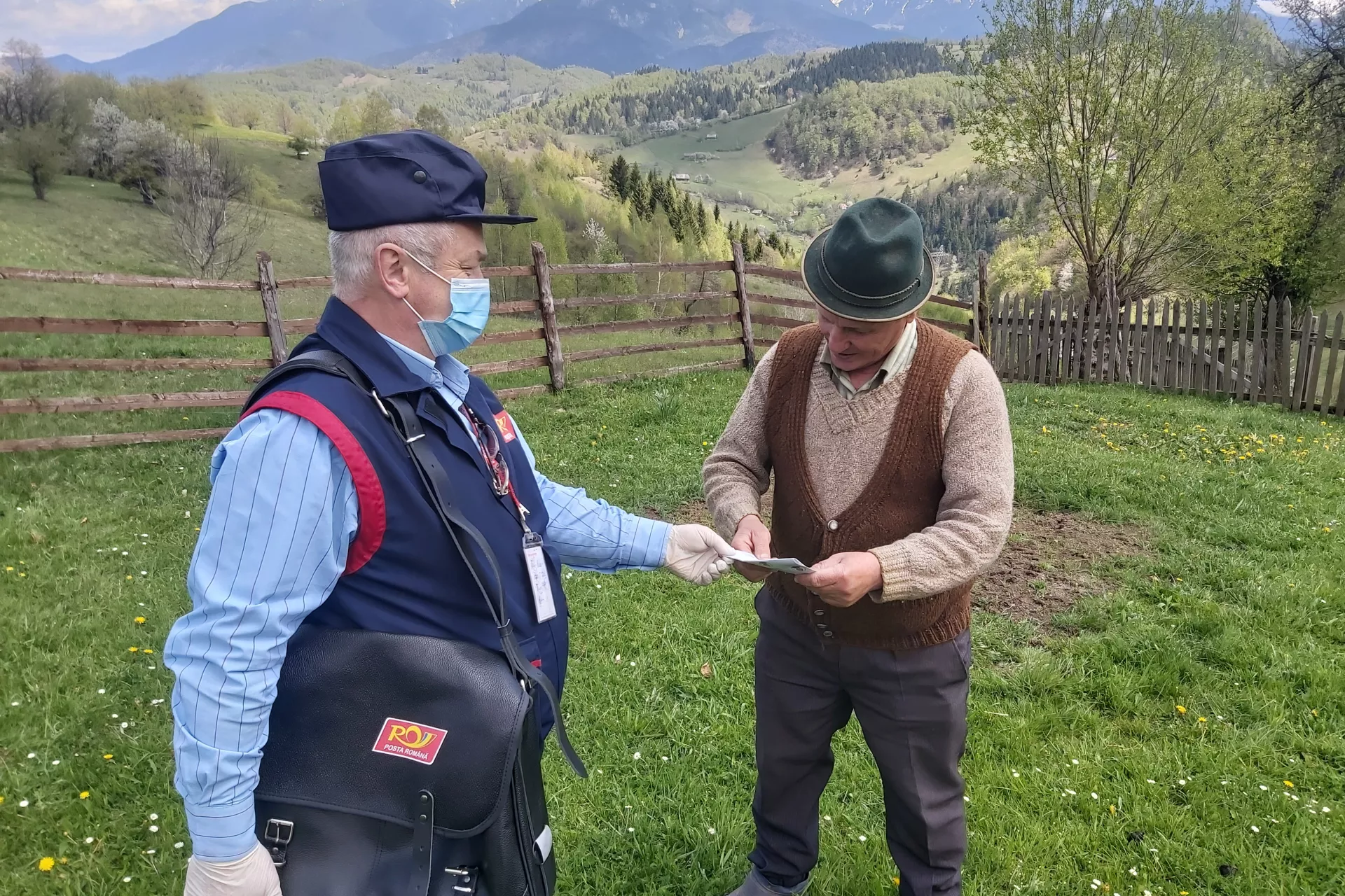 Postmaster Marian Cioacă delivers UNICEF flyers providing essential information on correct hygiene and prevention of COVID &ndash; 19 as well as ways to spend time in isolation in Moeciu de Jos, central Romania, on May 5, 2020.