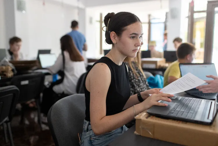 A girl looking at a laptop