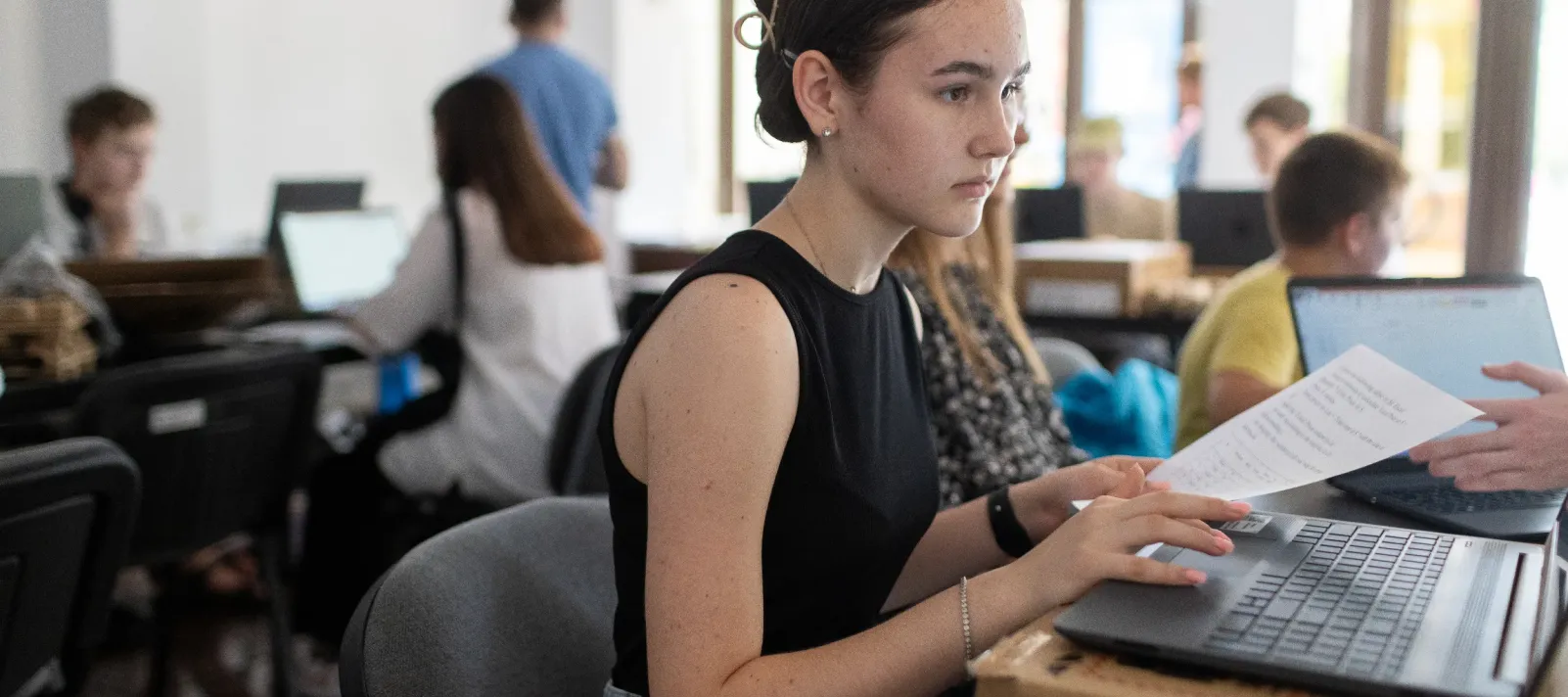 A girl looking at a laptop