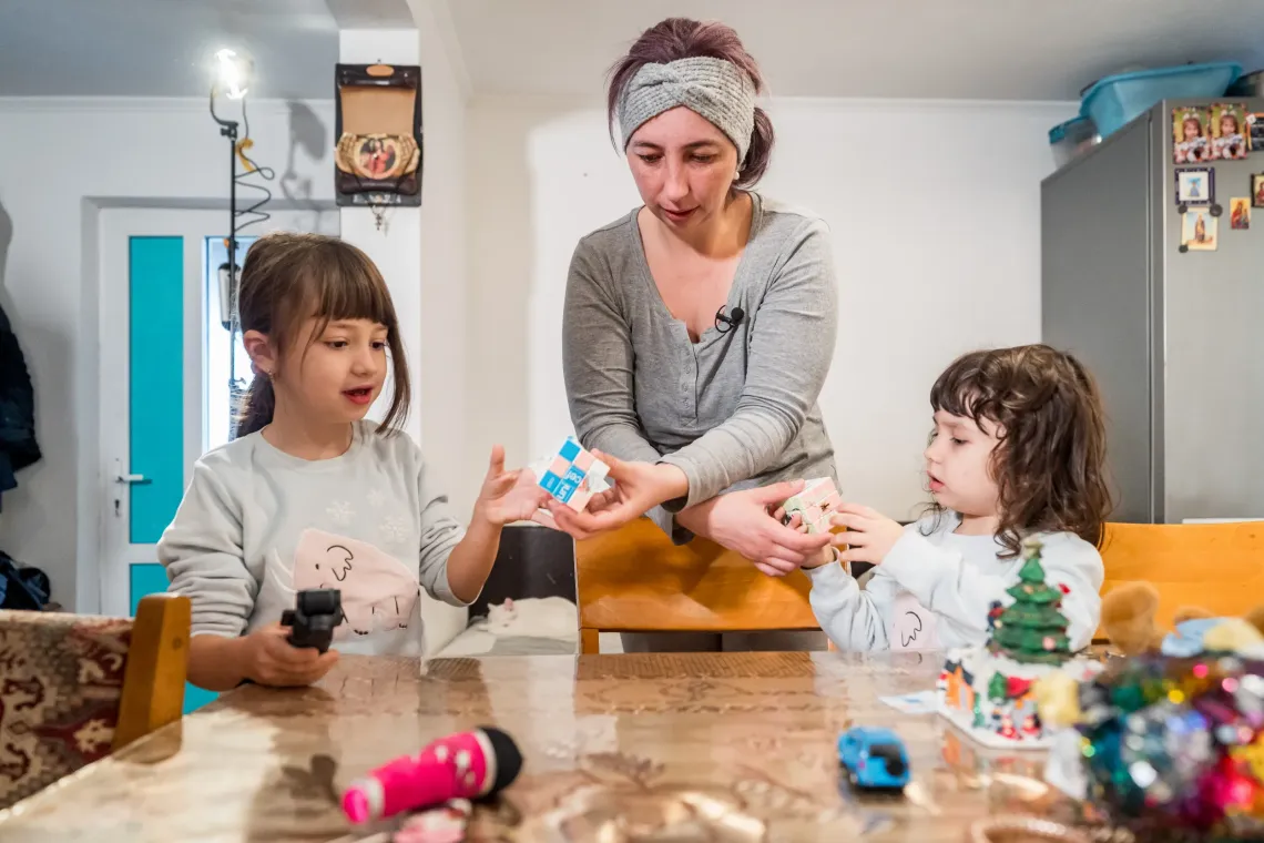 A mother and her two girls playing
