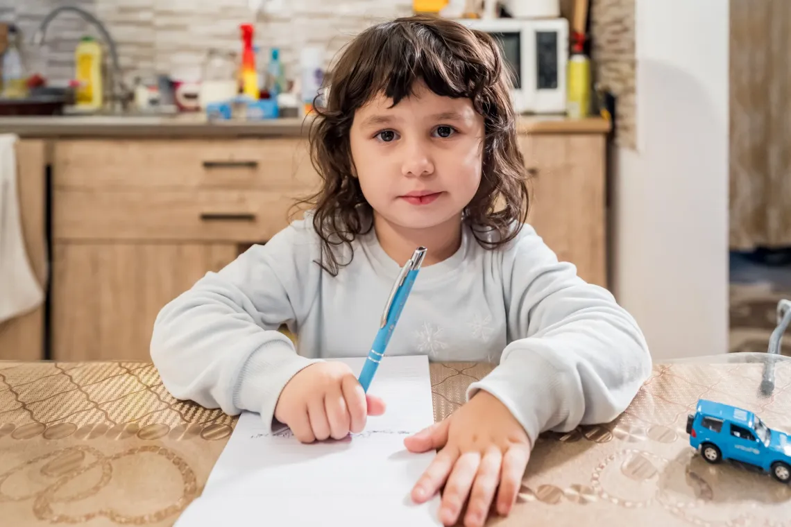 A girl writing at a table