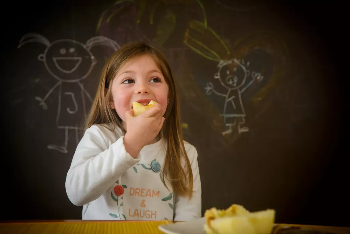 Jacinta, 4, eats an apple at her home in Montevideo, Uruguay. 