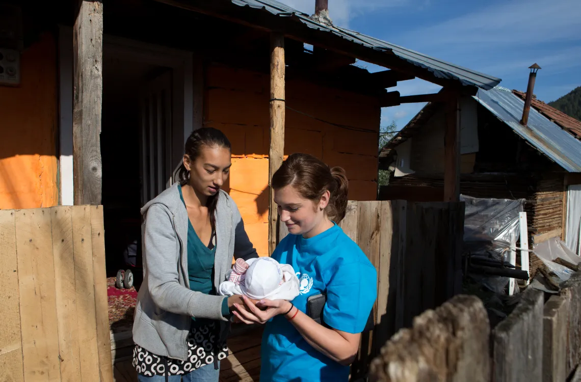 Andreea Ursaru together with her new born baby and a local professional - the community nurse
