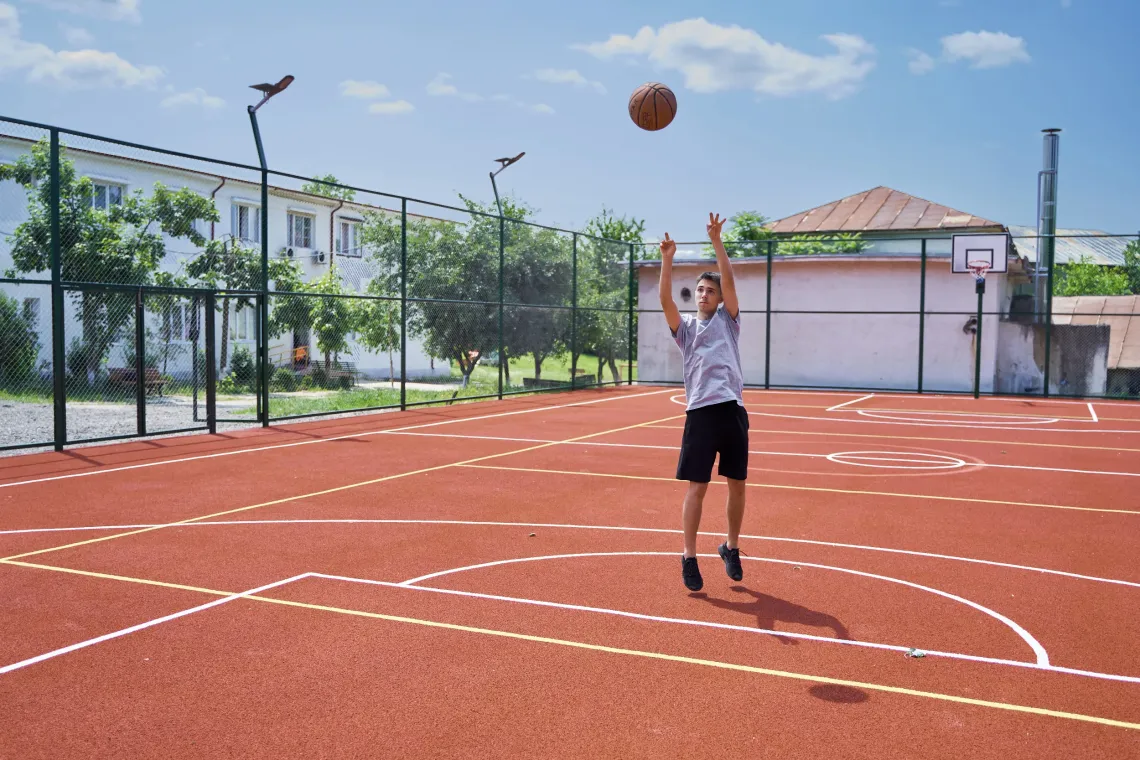 Young boy playing basketball.