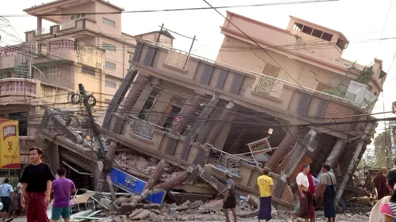 People in front of a collapsed building