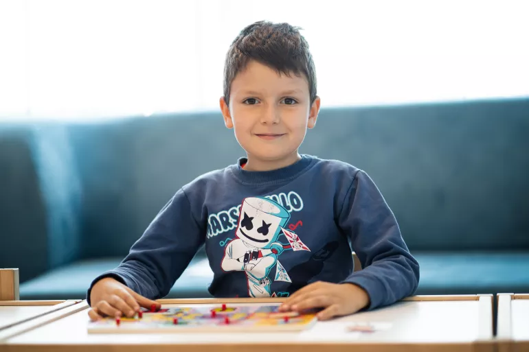A 4 year-old boy at a table for activities 