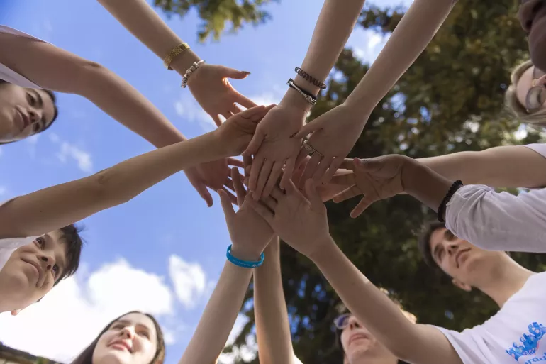 Adolescents joining hand