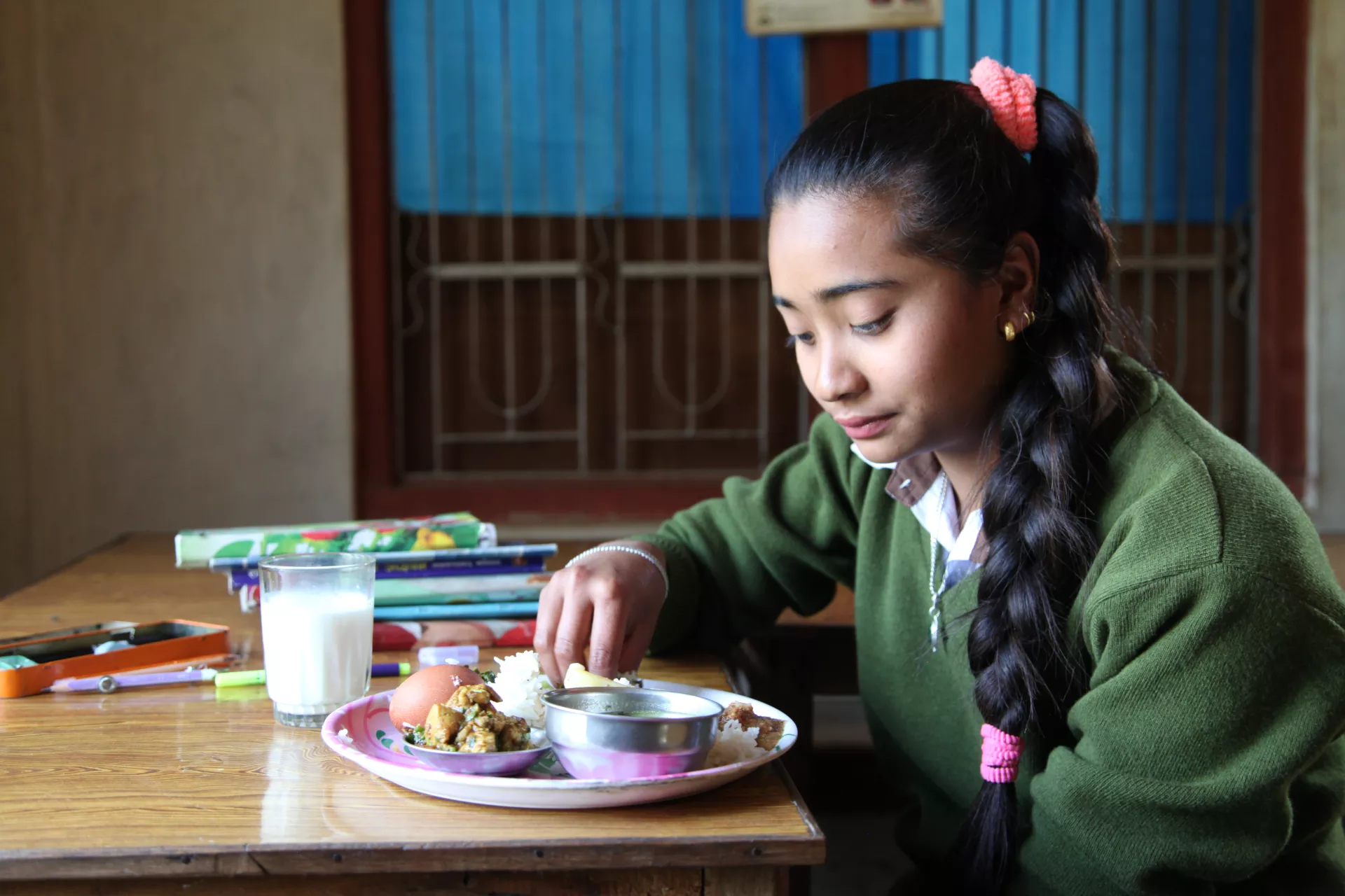 Young adolescent girl eating nutritious food in Nepal 