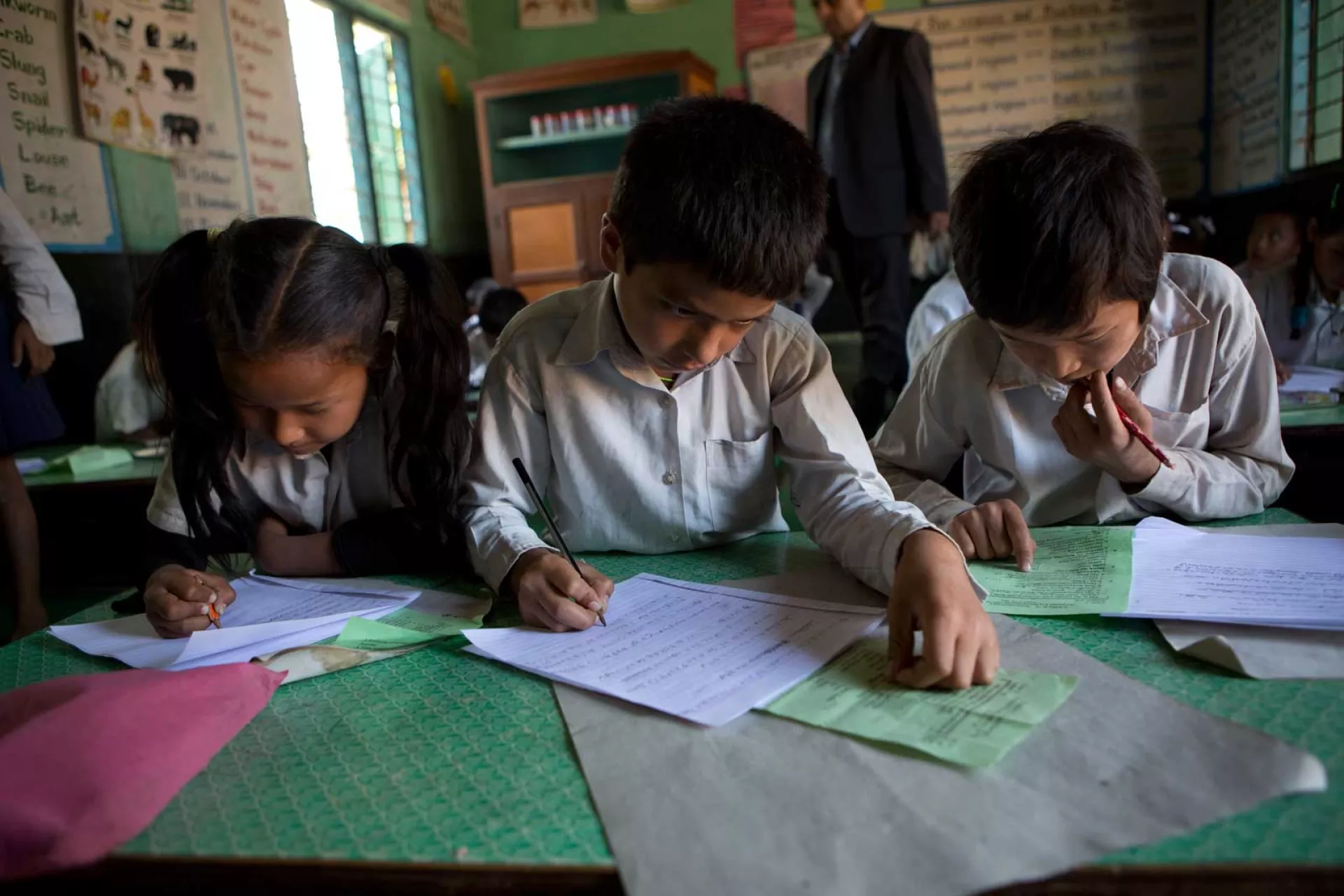 Children at desks doing school work
