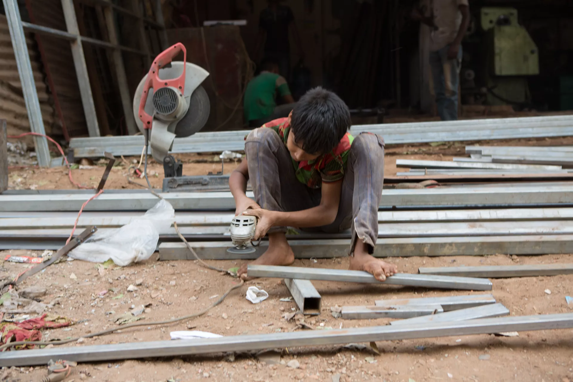 A young boy working in factory 