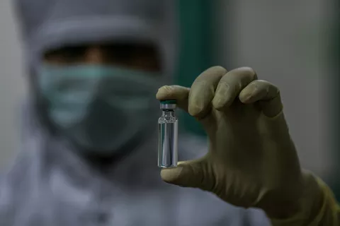 An employee holds a COVID-19 vaccine vial