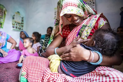 A mother provides breast feeding to her child at an Aanganwadi centre in Kolaras, Shivpuri.