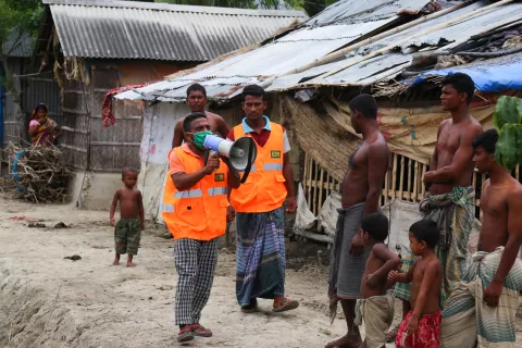 A UNICEF-supported Cyclone Preparedness Programme (CPP) volunteer uses a megaphone to urge residents to evacuate to shelters ahead of the expected landfall of cyclone Amphan in Khulna on May 19, 2020.