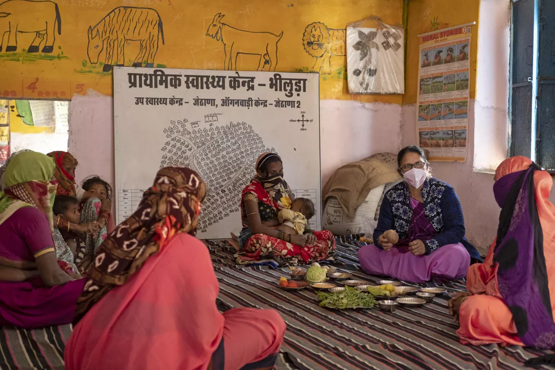 Vidhya Jain 55 &ndash; year &ndash; old (2nd right) Anganwadi worker talking to pregnant women and young mothers about the importance of nutritious food at the Jethana B Anganwadi center in Jethana village.