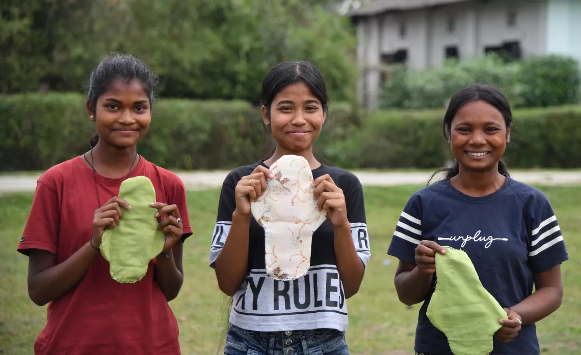 Members of the adolescent girls club hold sanitary pads