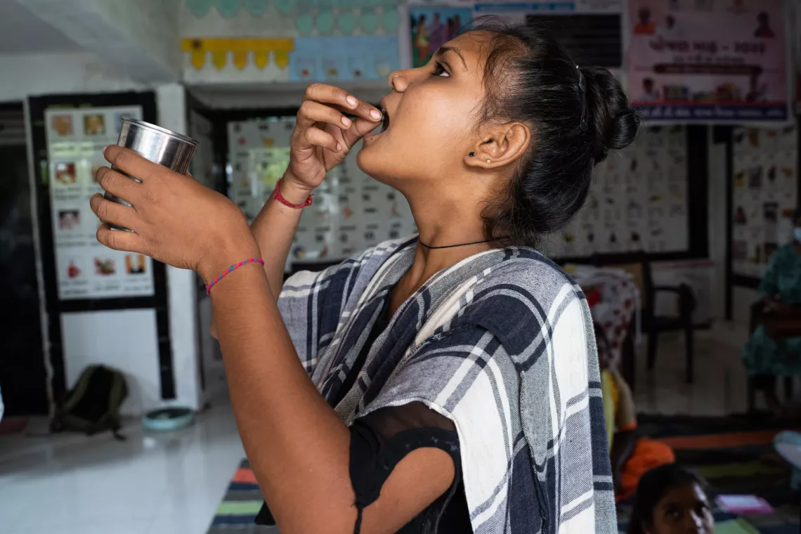 Kumari Preetiben Dineshbhai Vasava taking the IFA tablet.