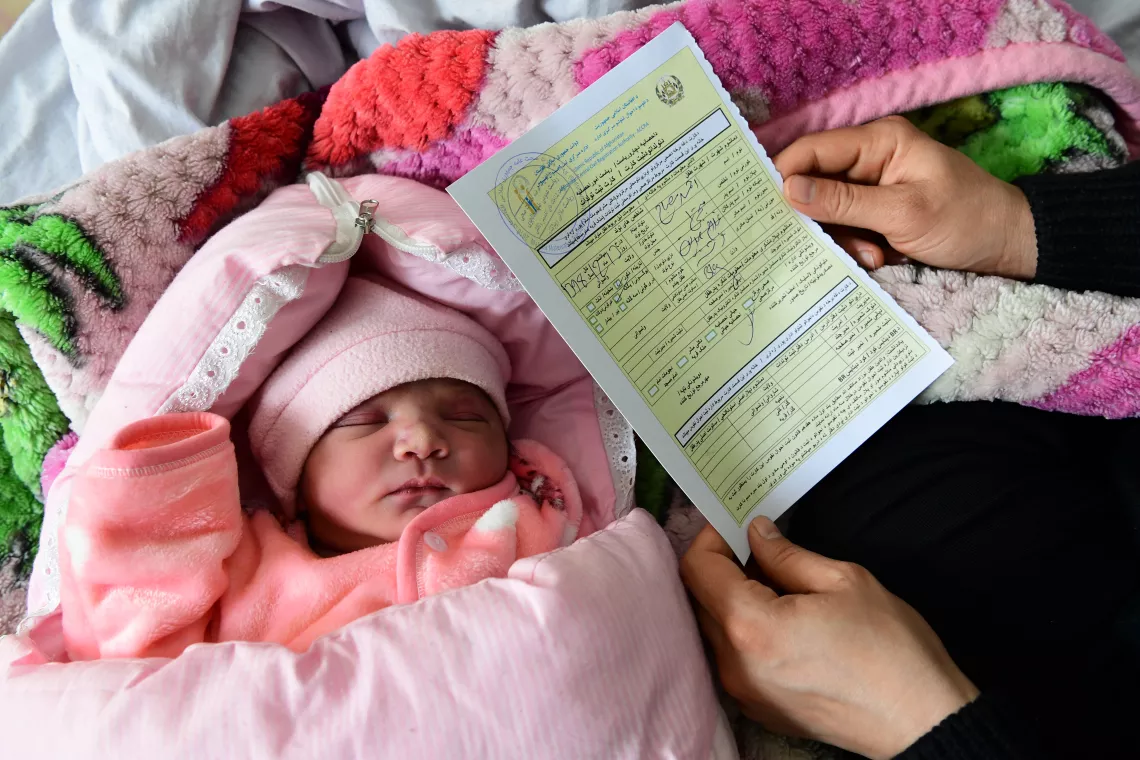 A mother received a birth certificate of her newborn baby, in the Malalai Hospital, in Kabul, the capital of Afghanistan.