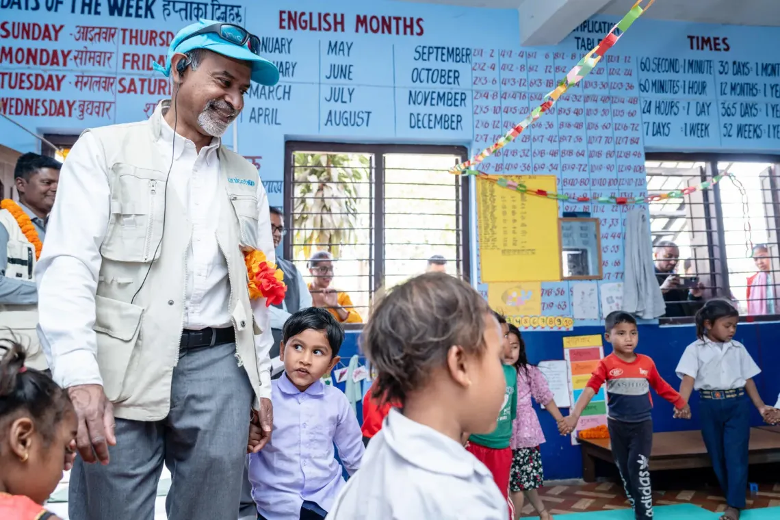 Sanjay participating in a play activity with children inside an Early Childhood Development Centre
