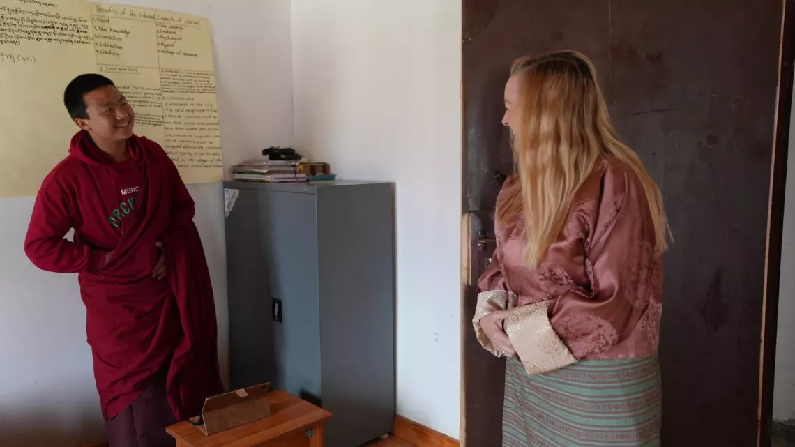 Emma Creighton, UNICEF Regional Chief of Supply in South Asia, chats in English with Chenga Tshering, a 15-year-old monk from the Talakha Monastic School.