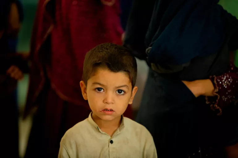 a boy stands in the waiting room of Jannat Gul Hospital in the suburb of Gujro