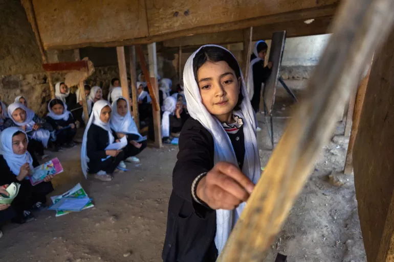 A girl is photographed in Batash School in Faizabad city, Badakhshan province, Afghanistan
