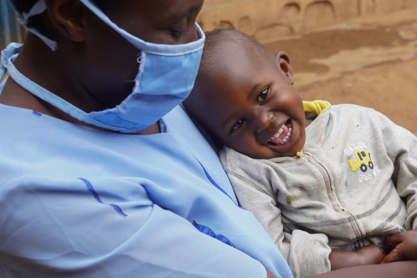 In Rwanda, a boy cuddles his mother, who wears a mask to prevent COVID-19, after receiving a healthy breakfast.
