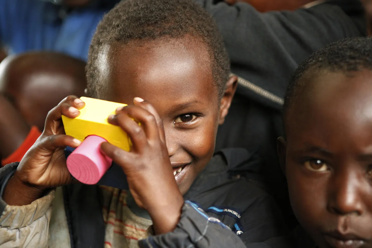 Small boy in Rwanda plays with toy blocks in early childhood development center