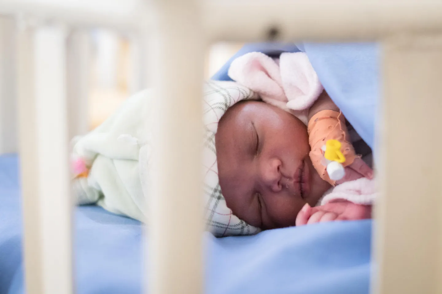 A baby in Rwanda rests in the hospital neonatal ward.