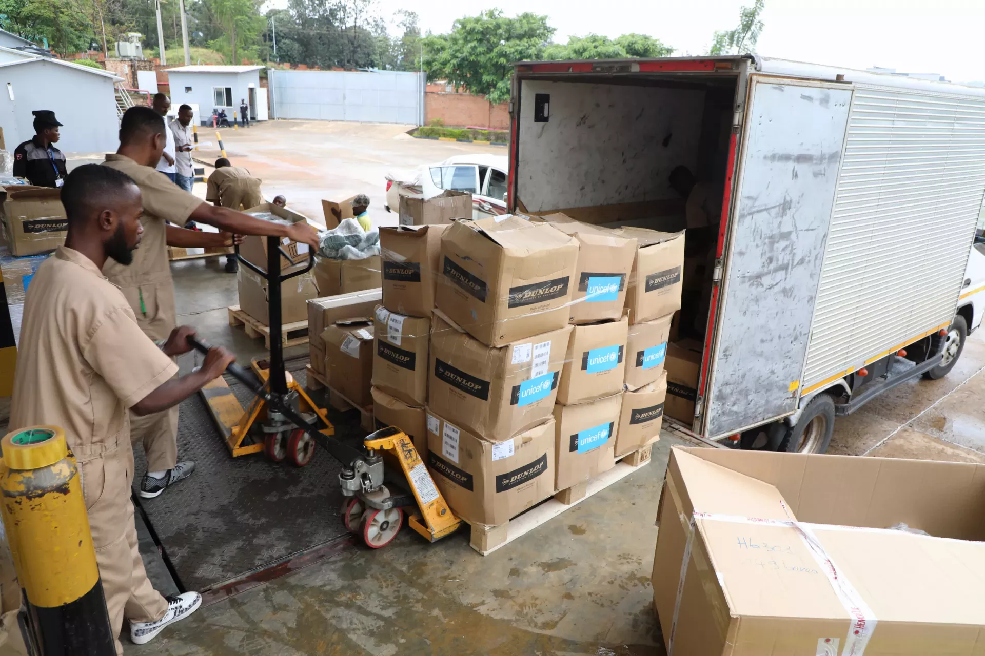 Boxes baring UNICEF branding being off-loaded.