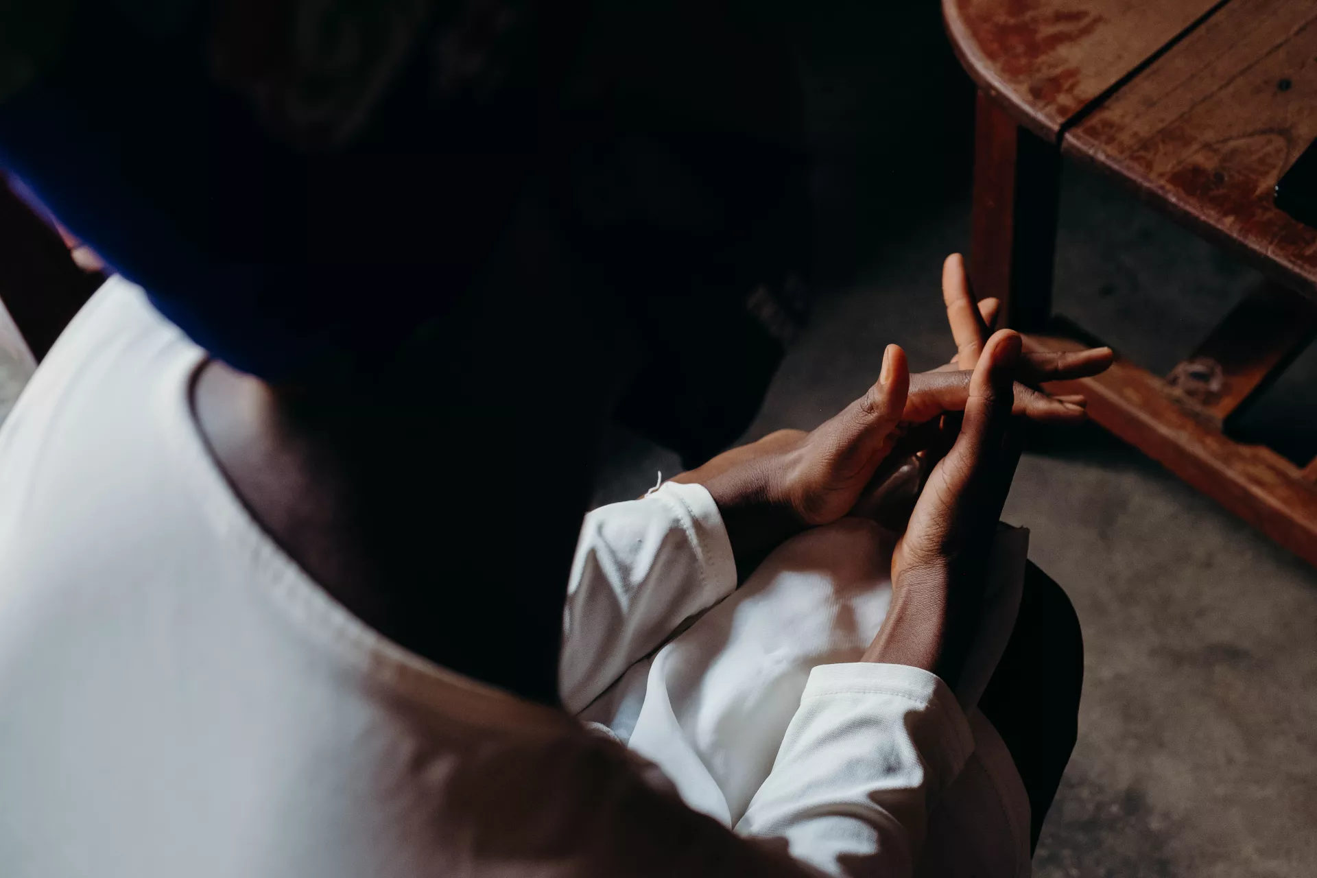 Alice, 23, twists her hands together as she tells her story of meeting UNICEF volunteers in her community.