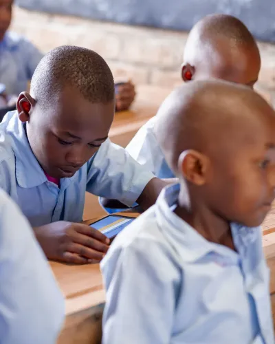 A child using a tablet to study in a classroom.
